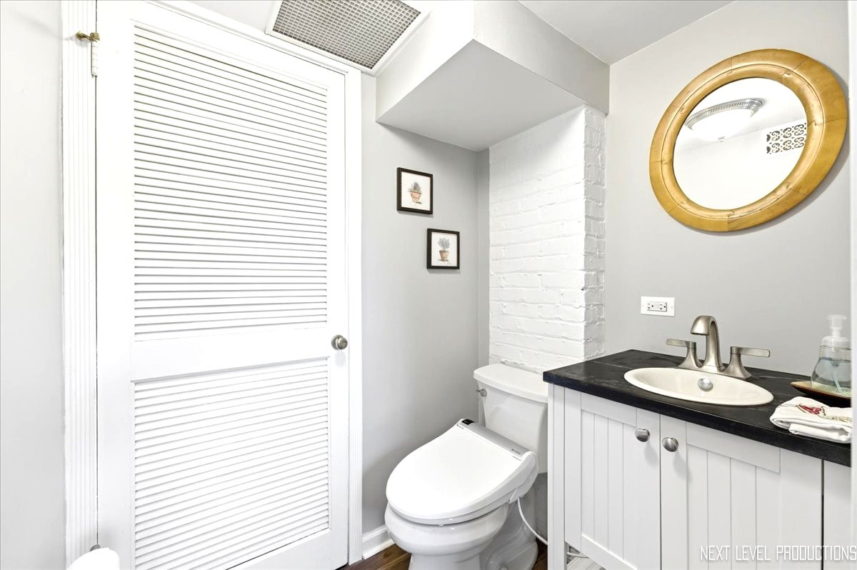 515 3rd Street Wilmette, IL 60091 - Photo 16 of 26 a bathroom with a toilet a sink and a mirror