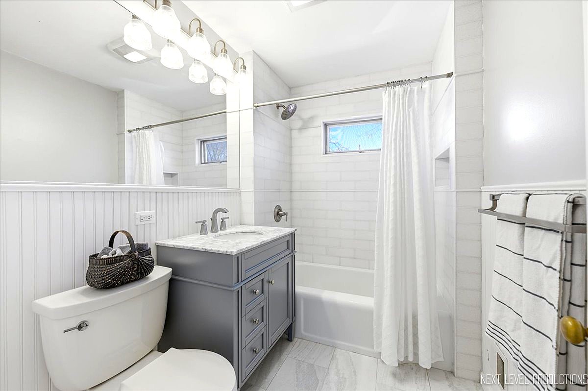 515 3rd Street Wilmette, IL 60091 - Photo 20 of 26 a bathroom with a sink a toilet and shower