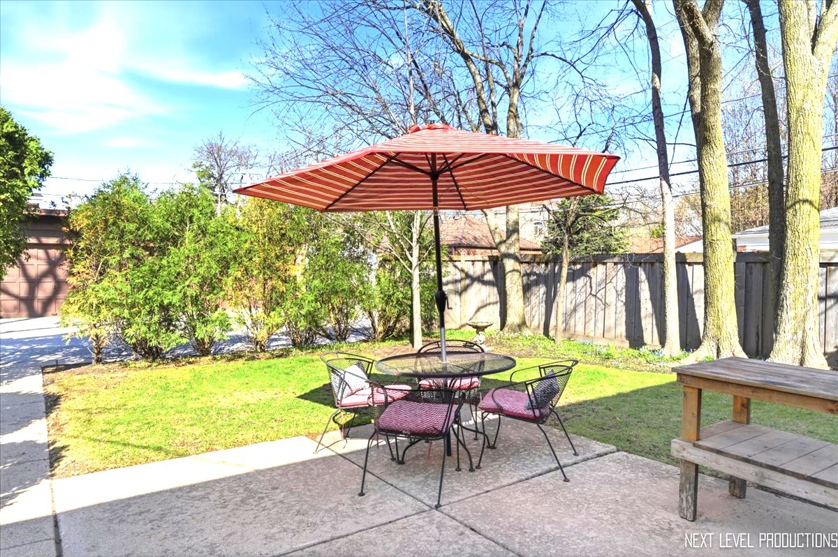 515 3rd Street Wilmette, IL 60091 - Photo 24 of 26 a backyard of a house with table and chairs