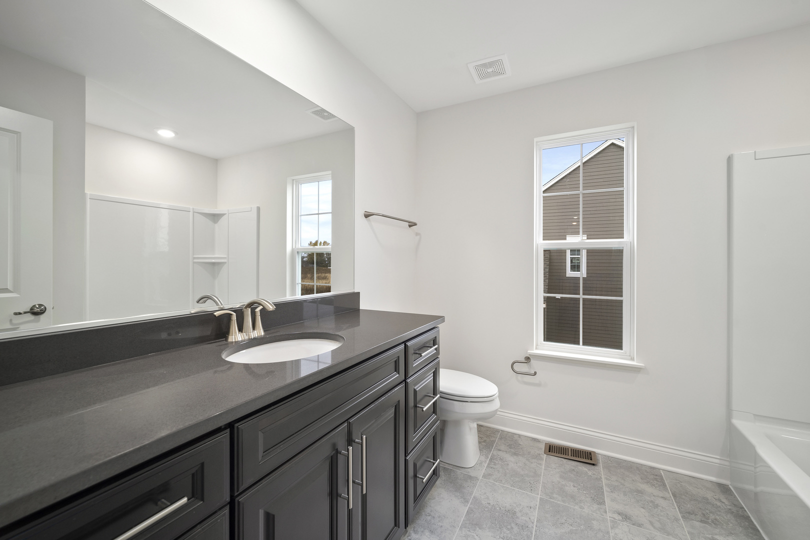 3657 Edelweiss Road Elgin, IL 60124 - Photo 11 of 24 a bathroom with a granite countertop sink a toilet and a mirror