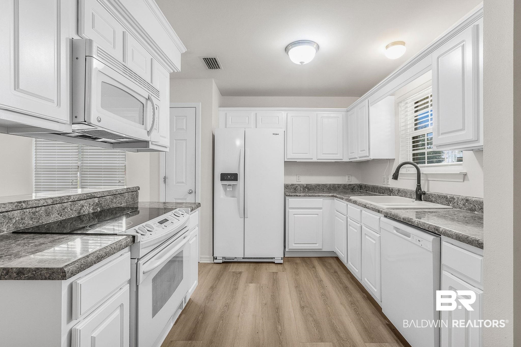 18620 Hammond Street Robertsdale, AL 36567 - Photo 6 of 23 Kitchen featuring light wood-type flooring, sink, white appliances, and white cabinets
