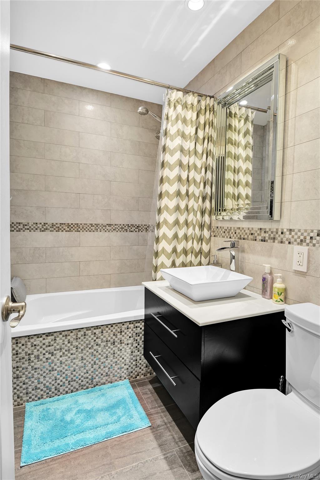 315 West 232nd Street, Unit 1F Bronx, NY 10463 - Photo 3 of 18 Bathroom featuring tile walls, tiled shower / bath, vanity, and recessed lighting