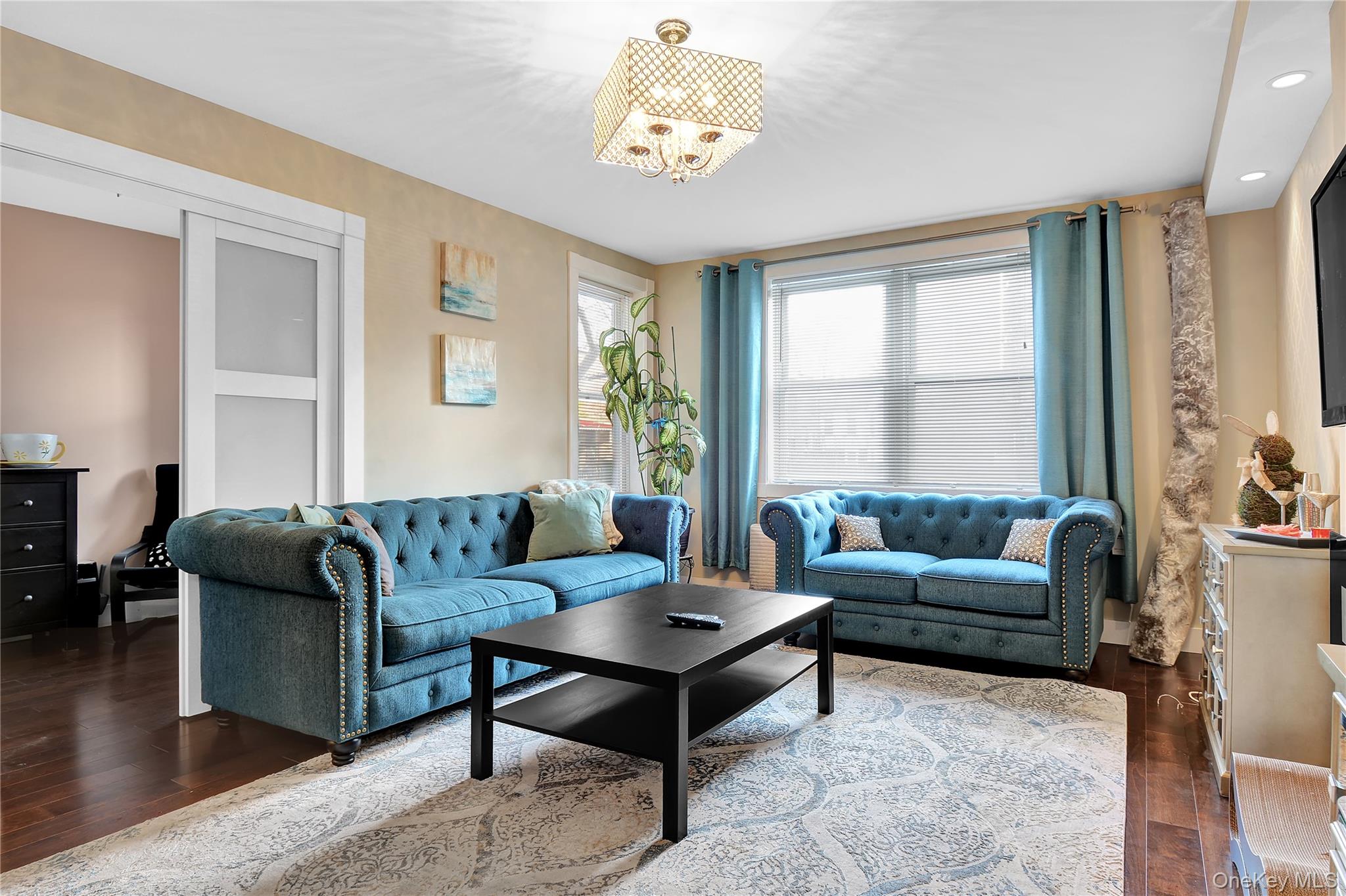 315 West 232nd Street, Unit 1F Bronx, NY 10463 - Photo 5 of 18 Living room featuring dark wood-type flooring, a chandelier, and recessed lighting