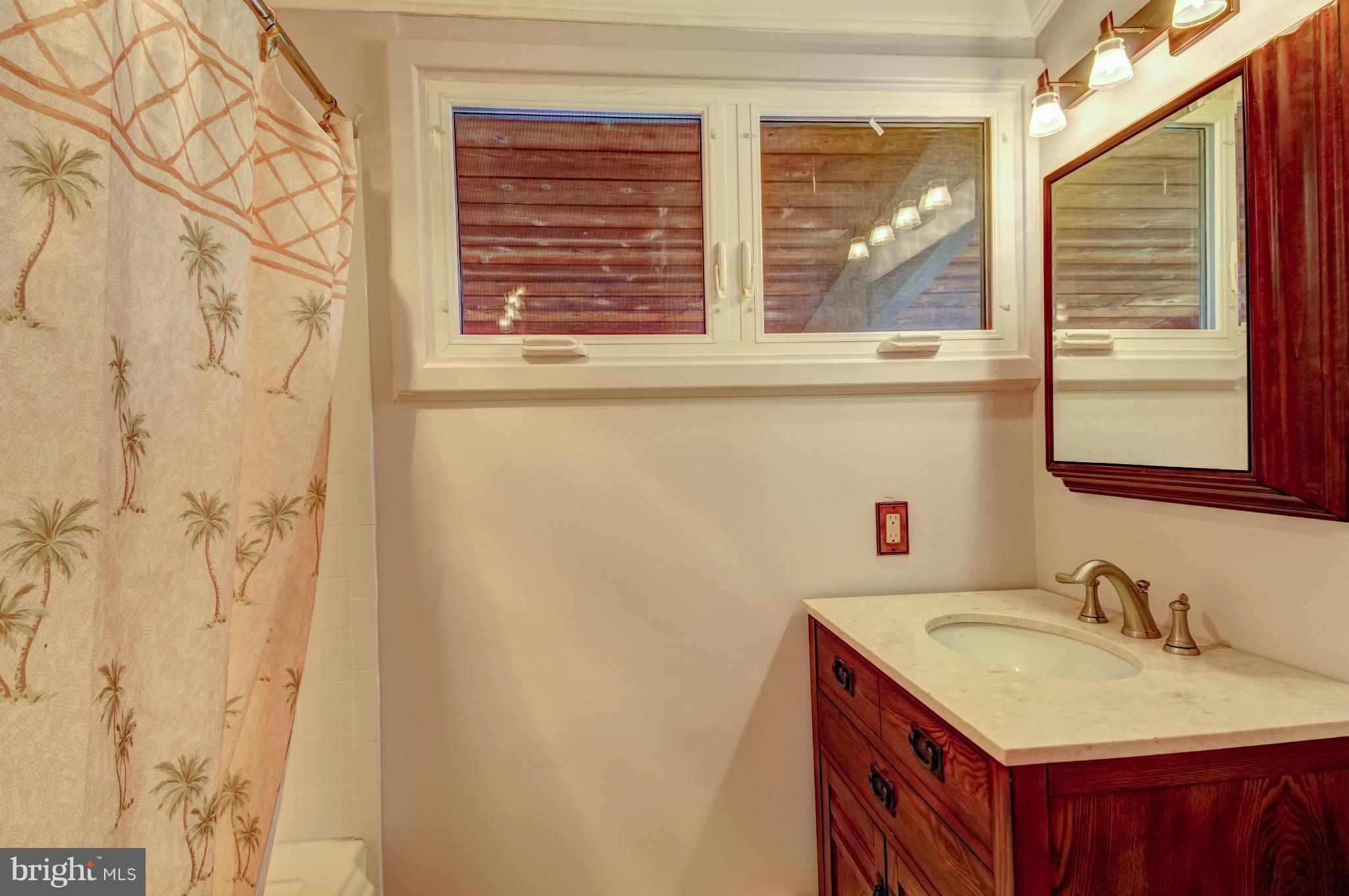 3381 Carroll Road Huntingtown, MD 20639 - Photo 12 of 30 a bathroom with a granite countertop sink and a window