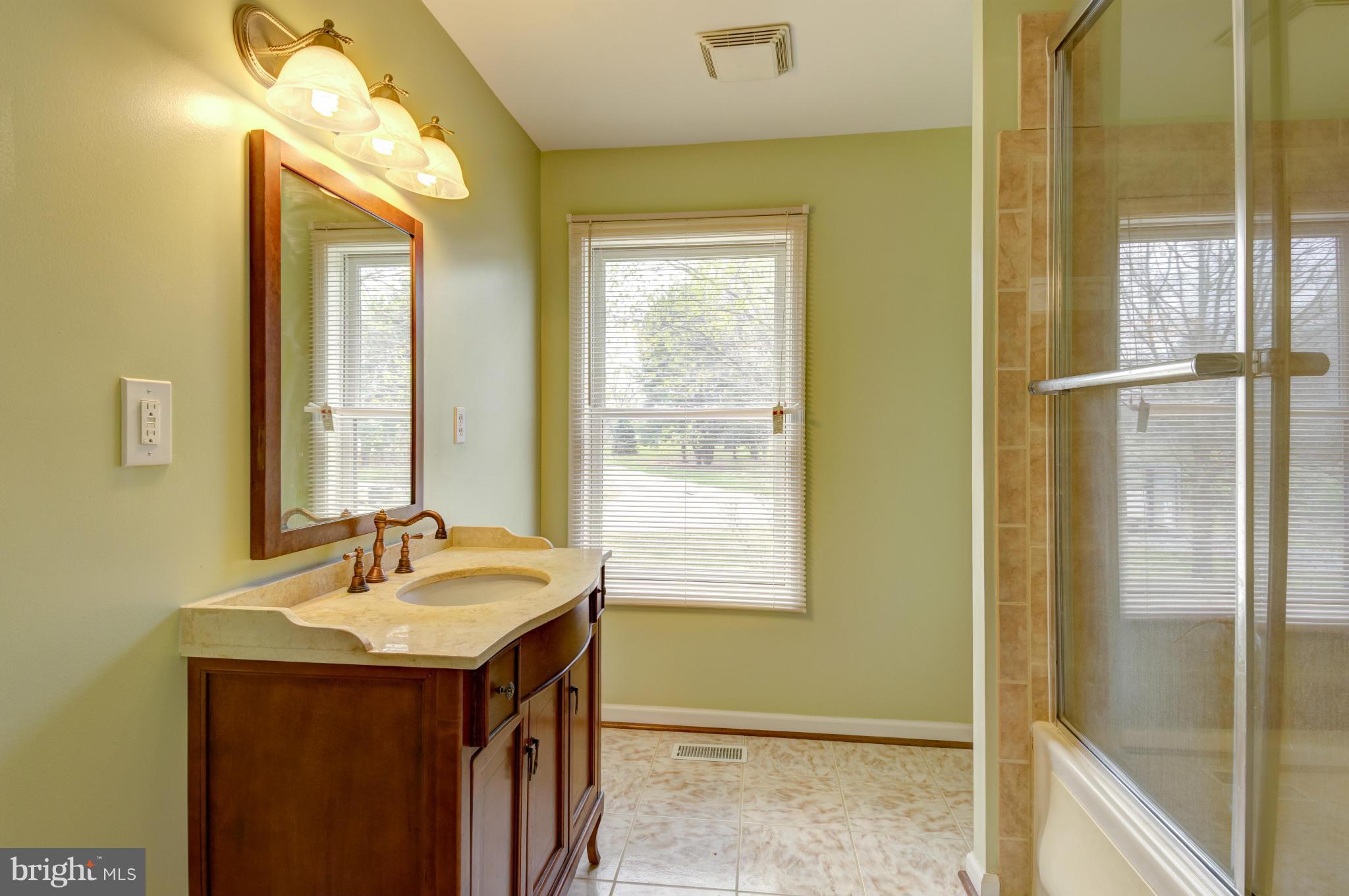 3381 Carroll Road Huntingtown, MD 20639 - Photo 14 of 30 a bathroom with a sink and a large mirror