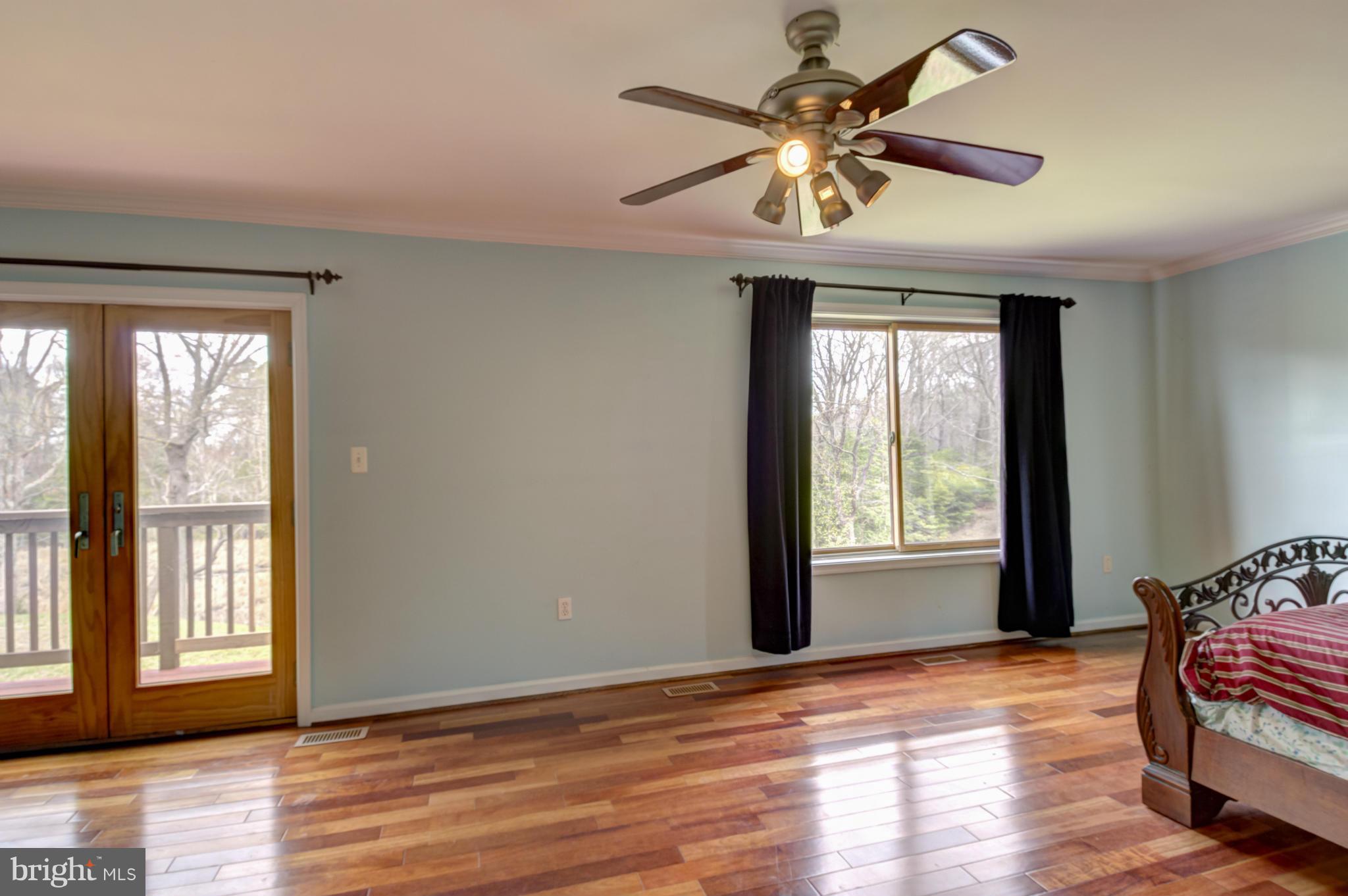 3381 Carroll Road Huntingtown, MD 20639 - Photo 15 of 30 a view of an empty room with wooden floor and a window