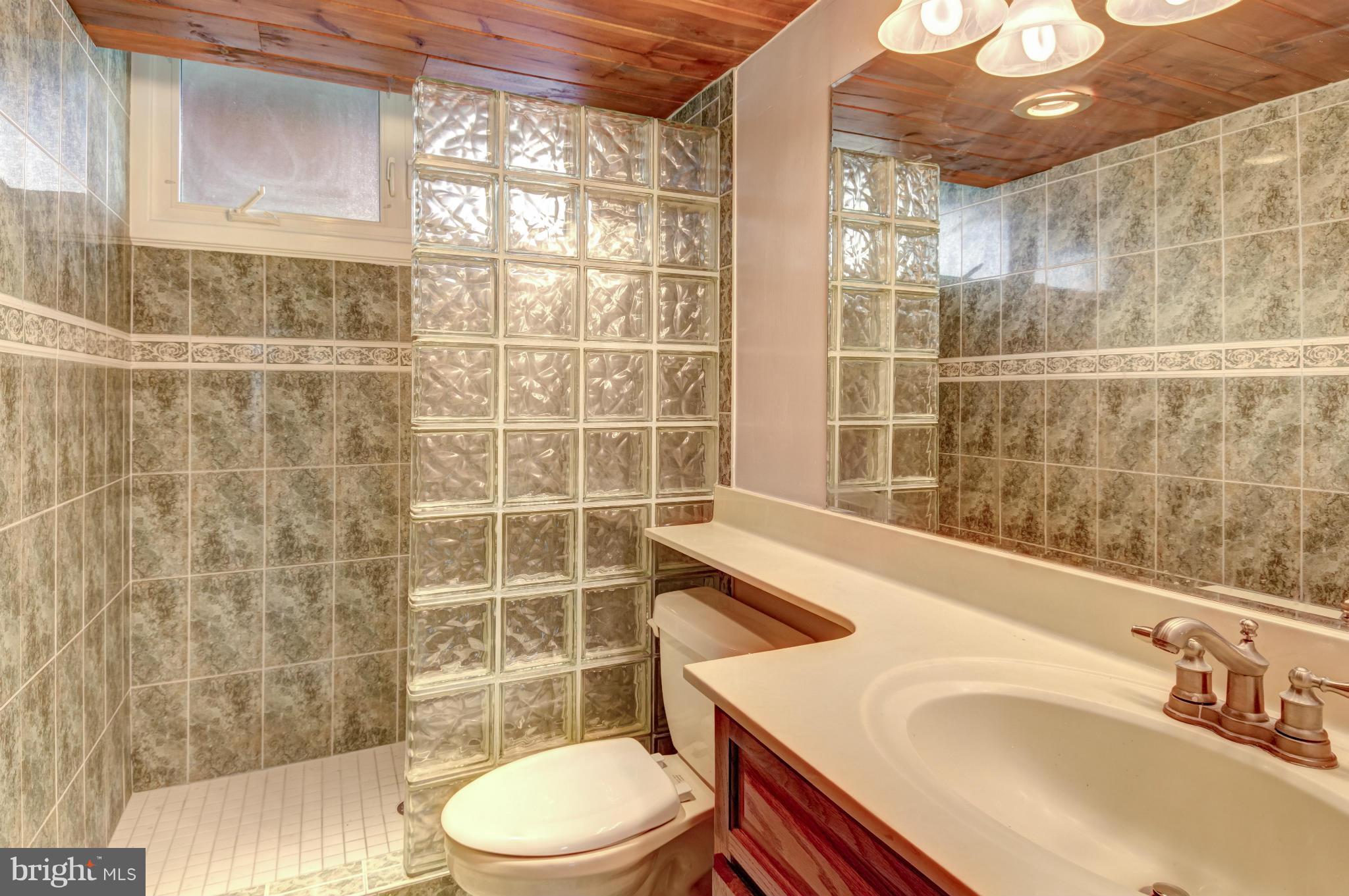 3381 Carroll Road Huntingtown, MD 20639 - Photo 19 of 30 a bathroom with a sink a toilet and shower