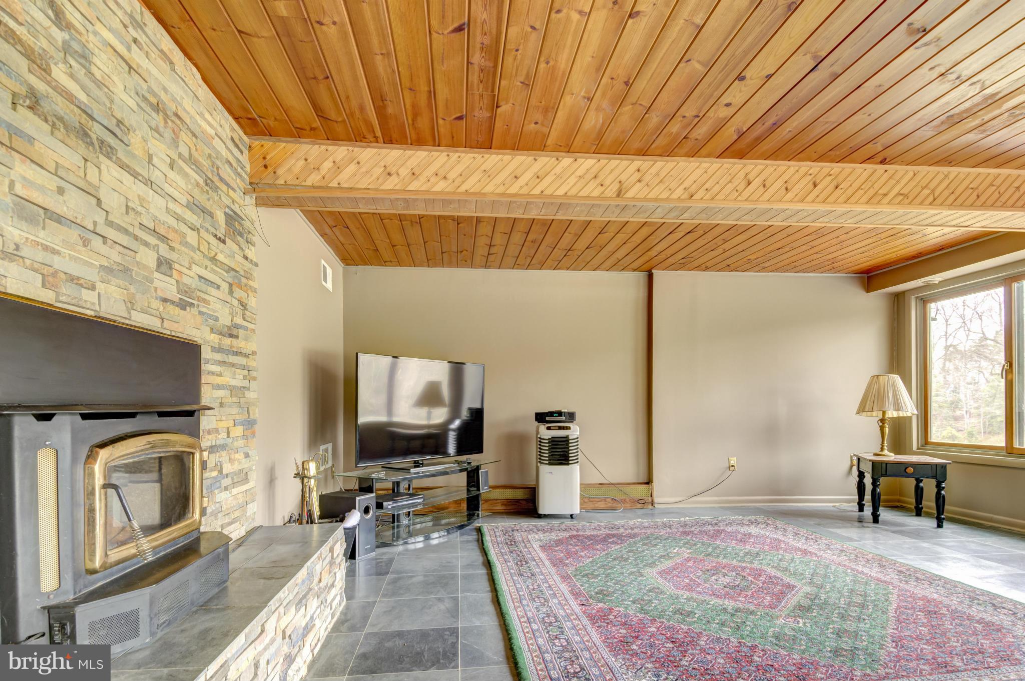 3381 Carroll Road Huntingtown, MD 20639 - Photo 23 of 30 a living room with furniture a flat screen tv and a fireplace