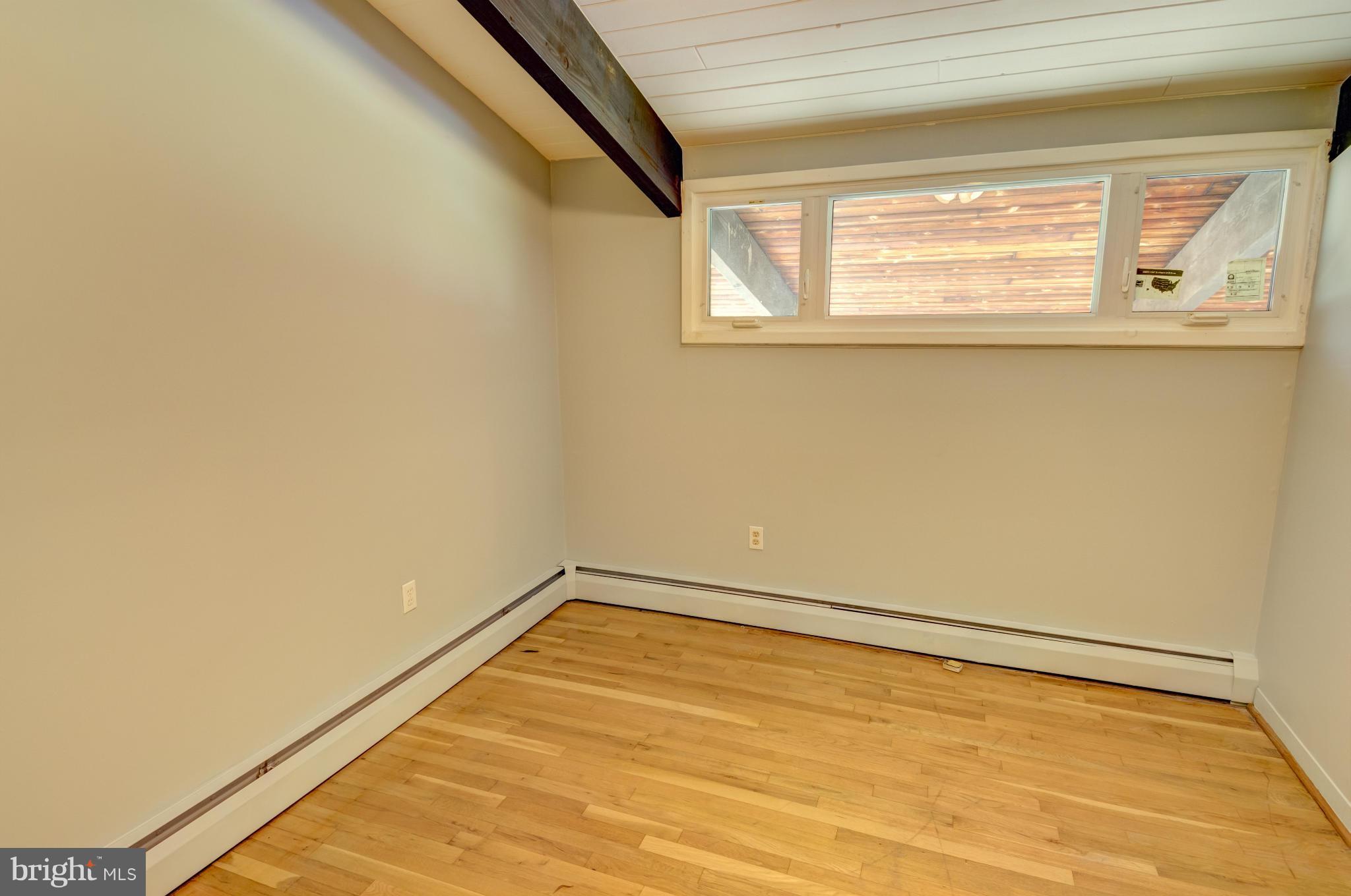 3381 Carroll Road Huntingtown, MD 20639 - Photo 27 of 30 a view of an empty room with wooden floor and a window