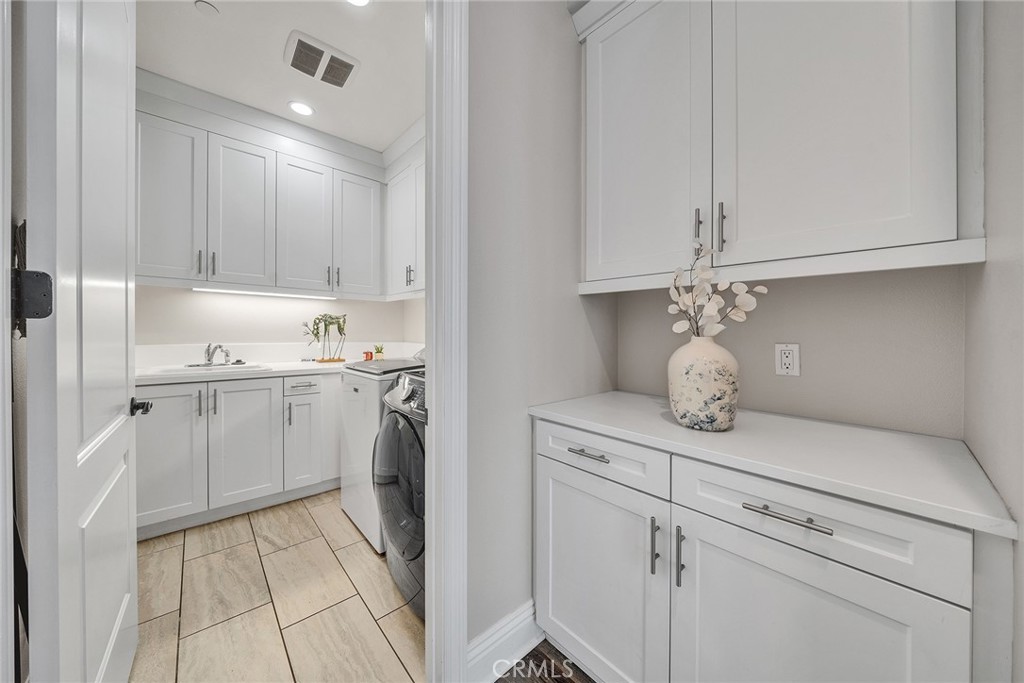 61 Windwalker Way Tustin, CA 92782 - Photo 11 of 62 a view of cabinets a sink and dishwasher in a kitchen
