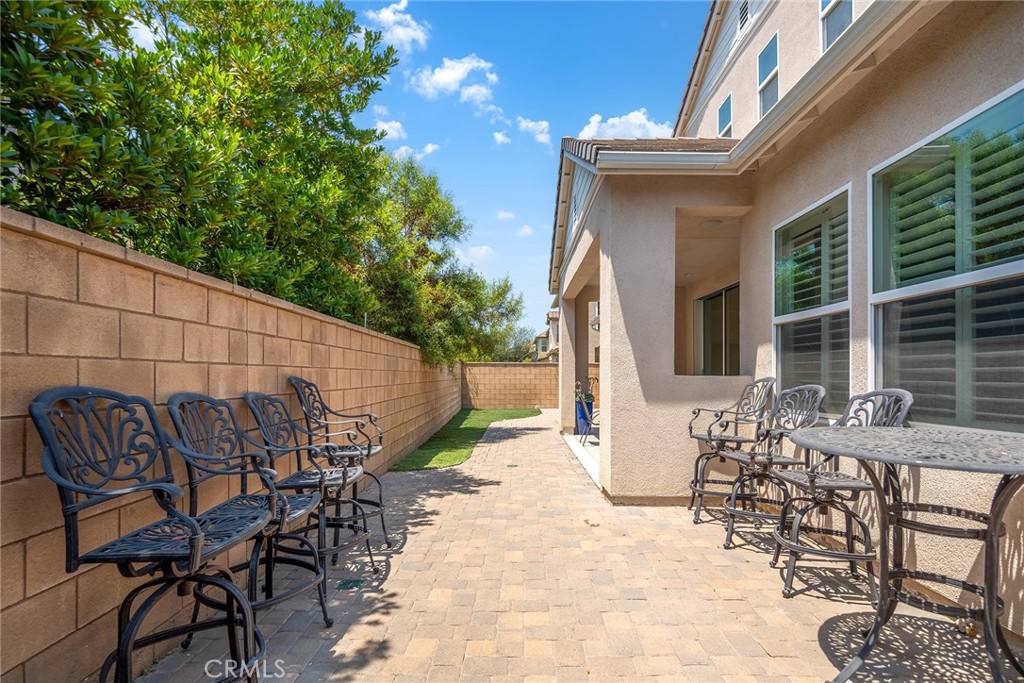 61 Windwalker Way Tustin, CA 92782 - Photo 15 of 62 a view of a patio with table and chairs and potted plants