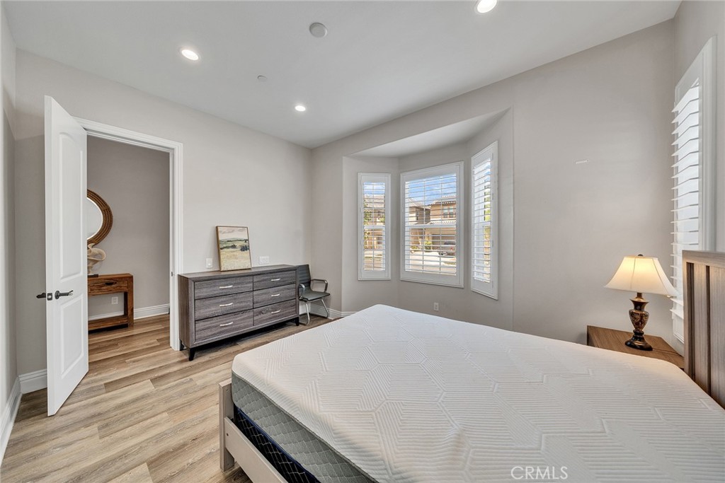 61 Windwalker Way Tustin, CA 92782 - Photo 17 of 62 a bedroom with a bed and wooden floor