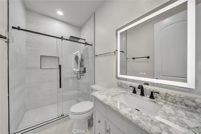 a bedroom with a bed and a wooden floor