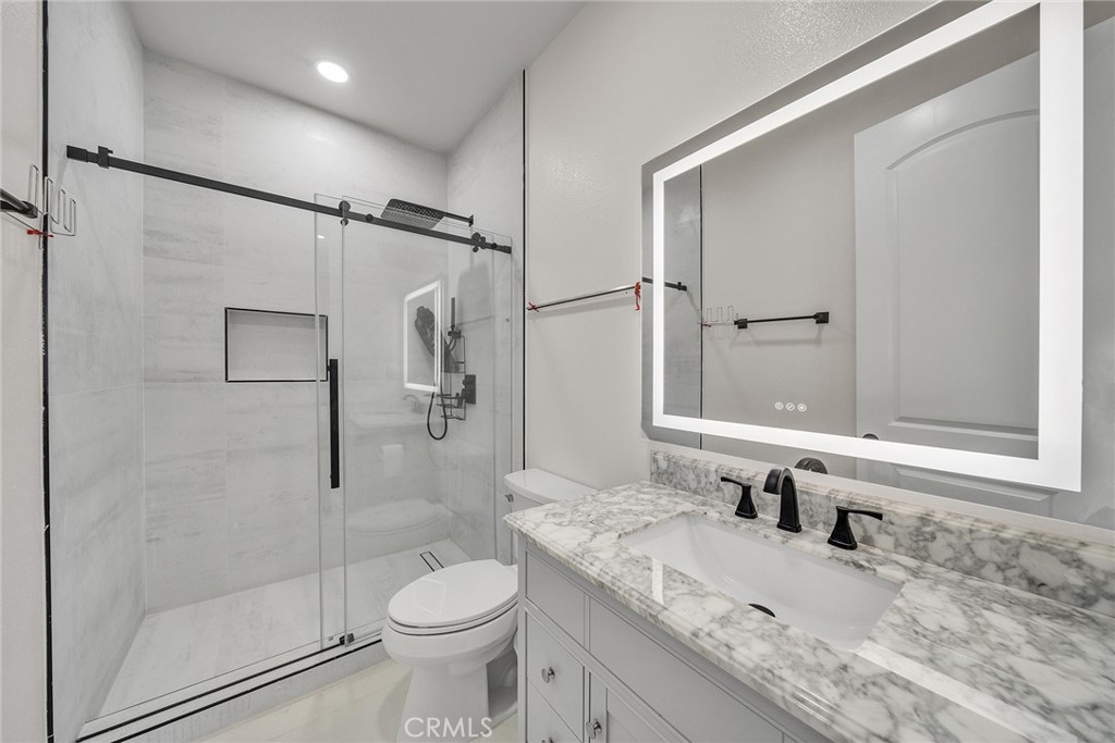 61 Windwalker Way Tustin, CA 92782 - Photo 18 of 62 a bathroom with a granite countertop sink toilet and shower