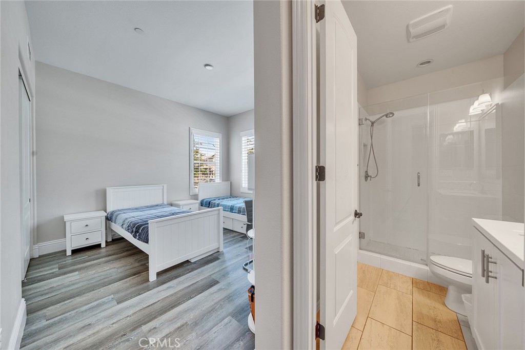 61 Windwalker Way Tustin, CA 92782 - Photo 20 of 62 a spacious bedroom with a bed and a chandelier