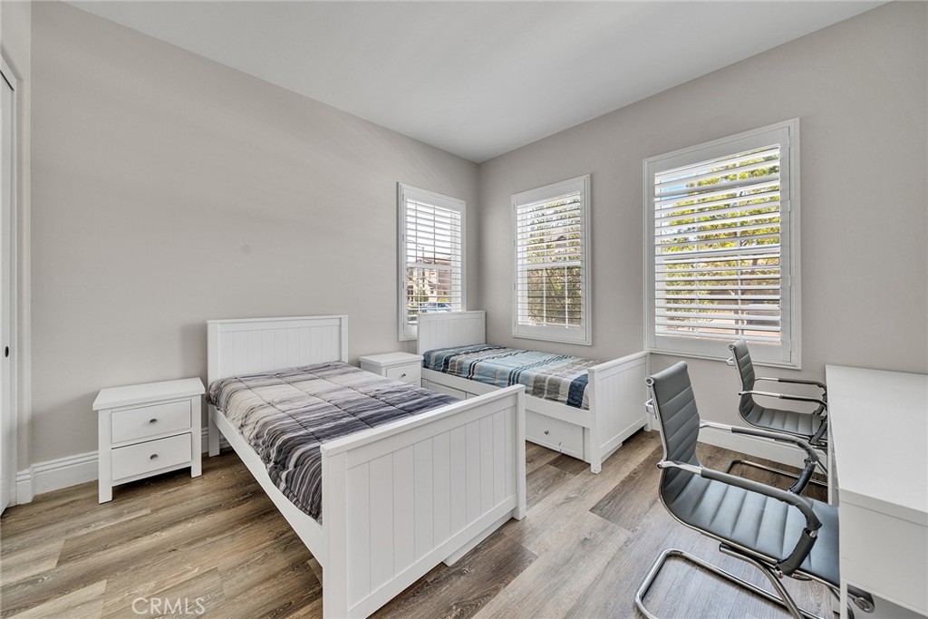 61 Windwalker Way Tustin, CA 92782 - Photo 22 of 62 a bedroom with a bed and a wooden floor