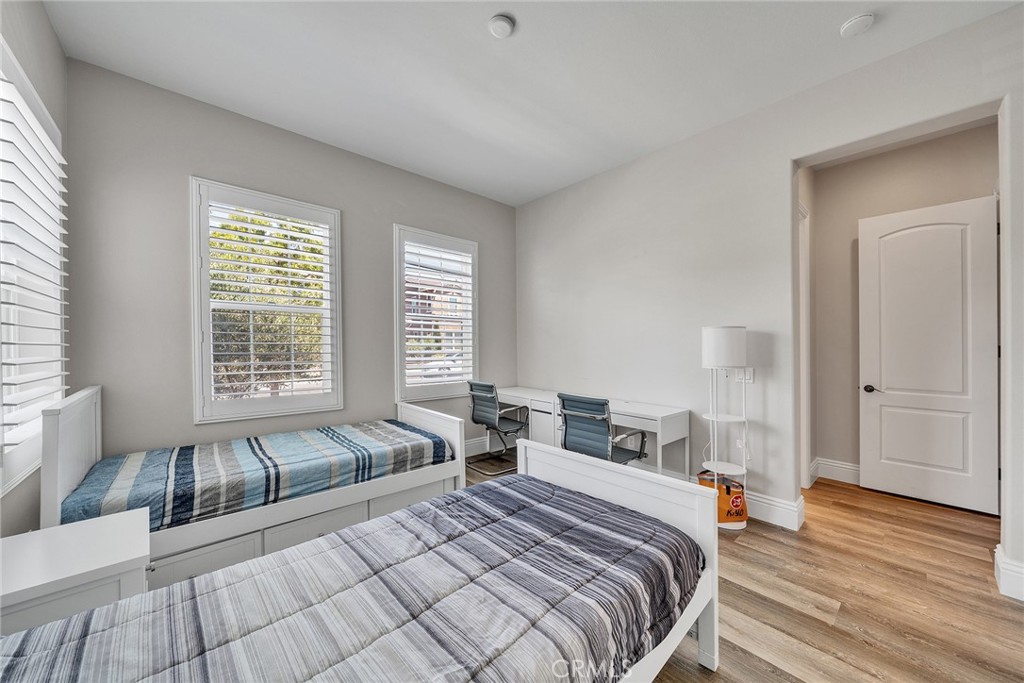 61 Windwalker Way Tustin, CA 92782 - Photo 23 of 62 a bedroom with two beds and a large window