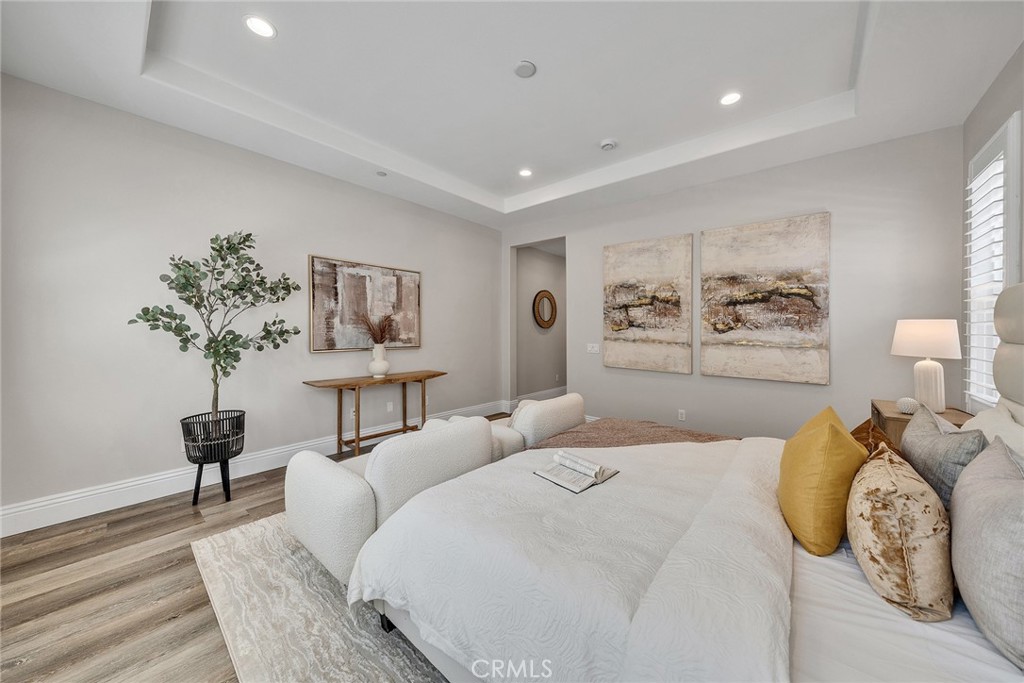 61 Windwalker Way Tustin, CA 92782 - Photo 26 of 62 a bedroom with a large bed and a chandelier