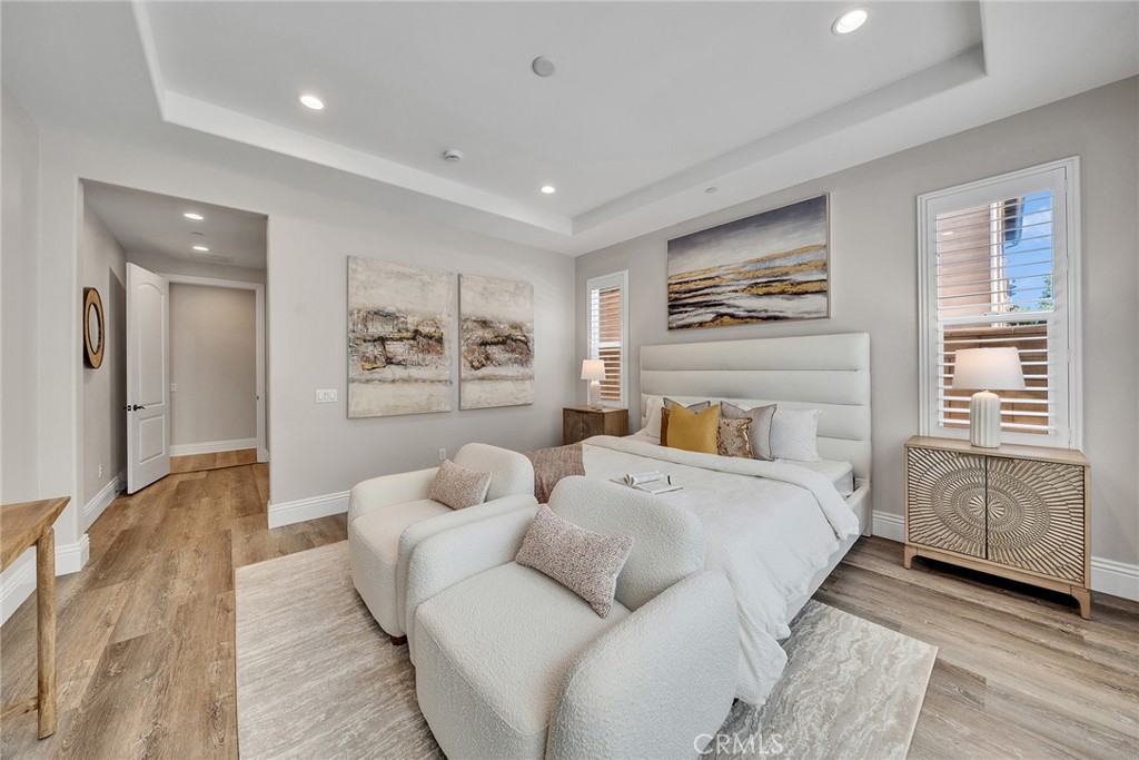 61 Windwalker Way Tustin, CA 92782 - Photo 32 of 62 a bedroom with a bed and wooden floor