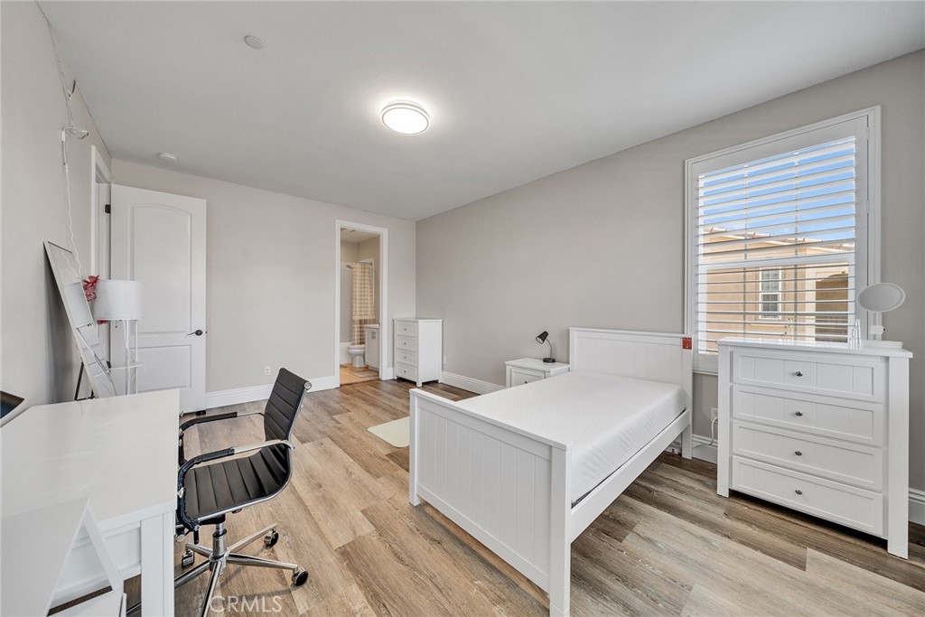 61 Windwalker Way Tustin, CA 92782 - Photo 39 of 62 a bedroom with a bed and a table in it