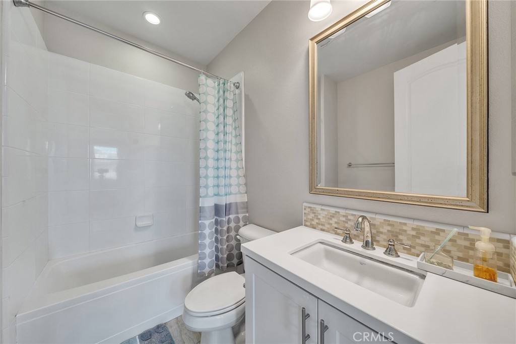 61 Windwalker Way Tustin, CA 92782 - Photo 40 of 62 a bathroom with a sink toilet vanity and shower