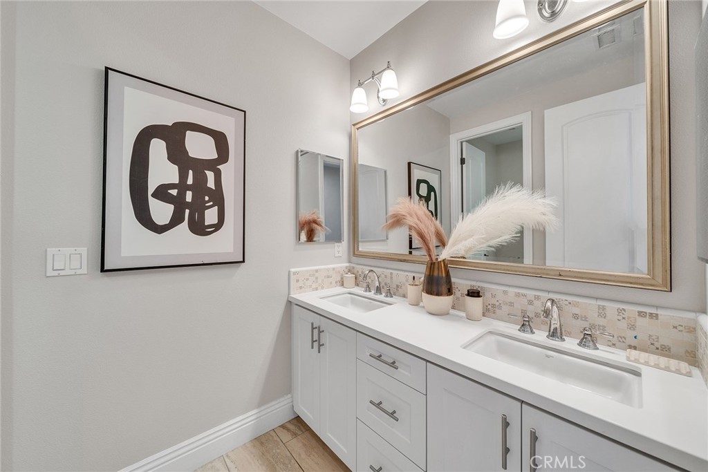 61 Windwalker Way Tustin, CA 92782 - Photo 42 of 62 a bathroom with a granite countertop sink and a mirror