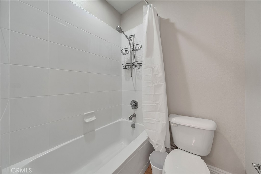 61 Windwalker Way Tustin, CA 92782 - Photo 43 of 62 a white toilet sitting next to a bath tub and a shower