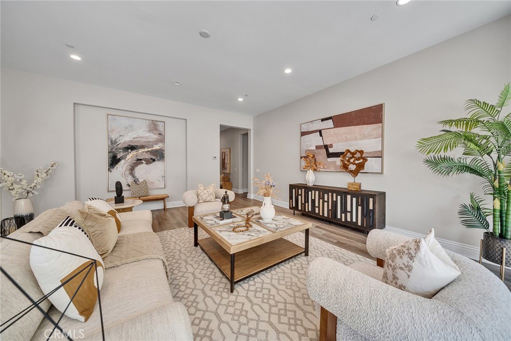 61 Windwalker Way Tustin, CA 92782 - Photo 5 of 62 a living room with furniture a rug and a potted plant
