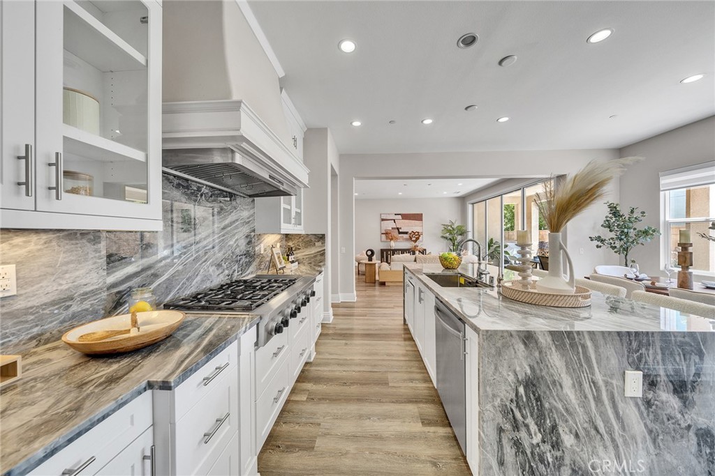 61 Windwalker Way Tustin, CA 92782 - Photo 6 of 62 a kitchen with stainless steel appliances granite countertop a stove and a sink