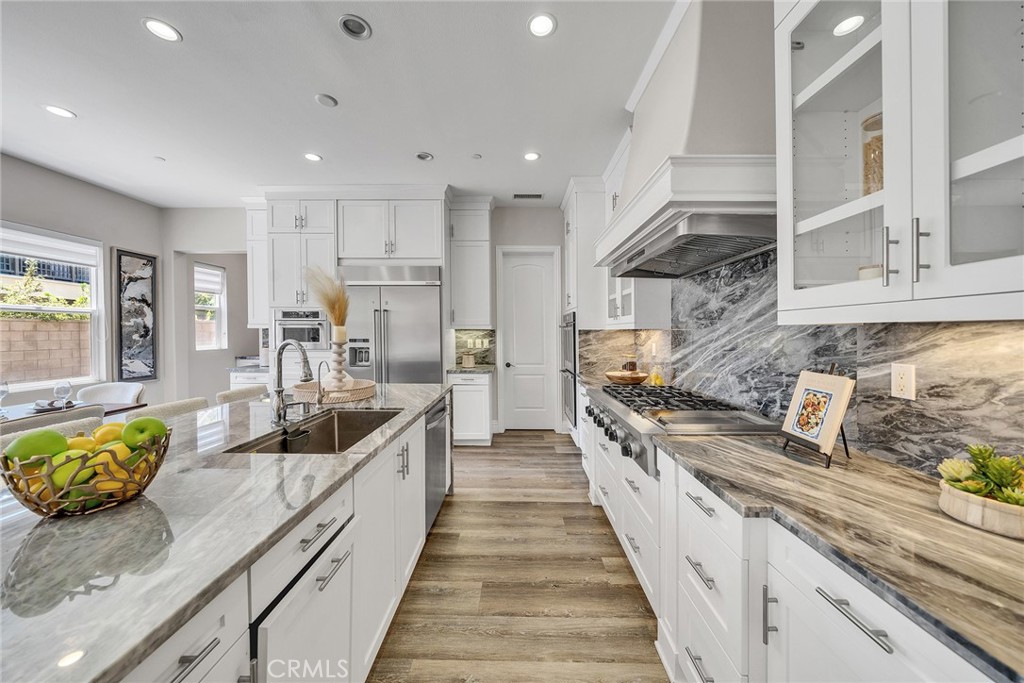 61 Windwalker Way Tustin, CA 92782 - Photo 8 of 62 a large kitchen with stainless steel appliances granite countertop a lot of counter space
