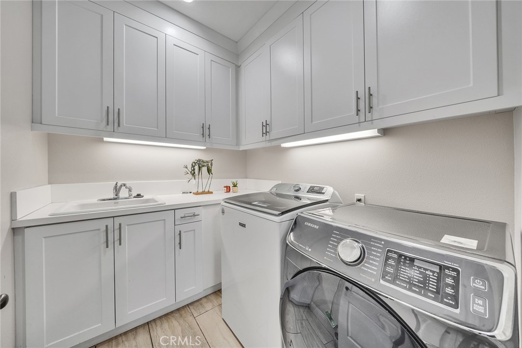 61 Windwalker Way Tustin, CA 92782 - Photo 10 of 62 a utility room with sink dryer and washer