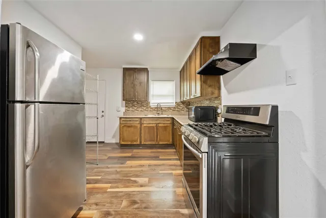 a kitchen with a stove and a refrigerator