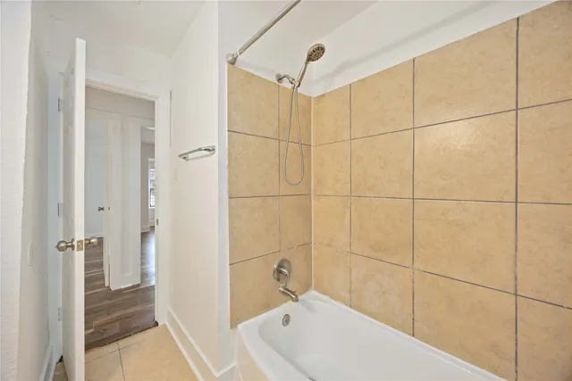 a bathroom with a bathtub and shower