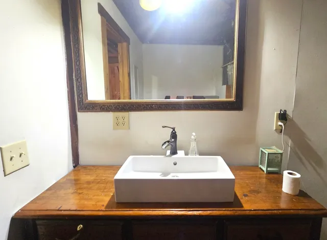 a bathroom with a sink and a mirror