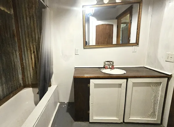 a kitchen with kitchen island granite countertop a sink and a stove