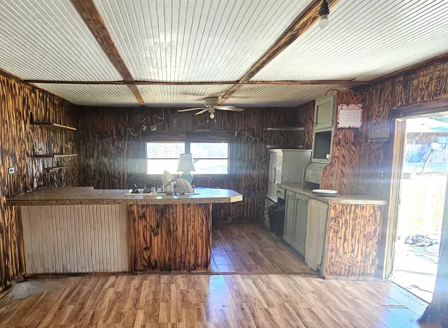 a kitchen with kitchen island granite countertop a sink and a stove