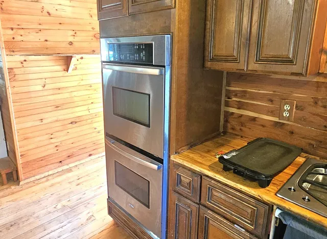 a stove top oven sitting inside of a kitchen