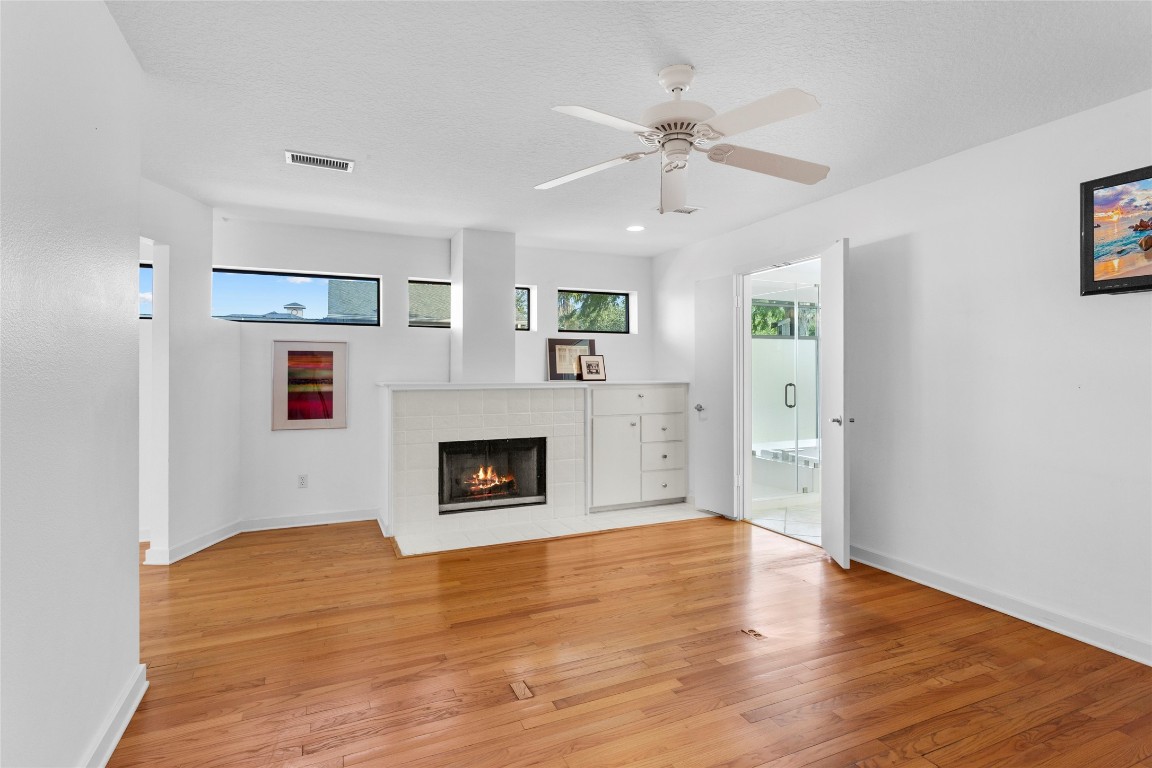67 Harbor Lane Kemah, TX 77565 - Photo 15 of 47 a view of livingroom with fireplace wooden floor and window