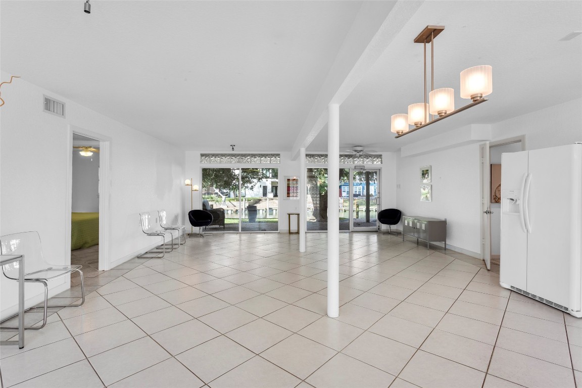 67 Harbor Lane Kemah, TX 77565 - Photo 25 of 47 a view of a living room and chandelier fan and kitchen view