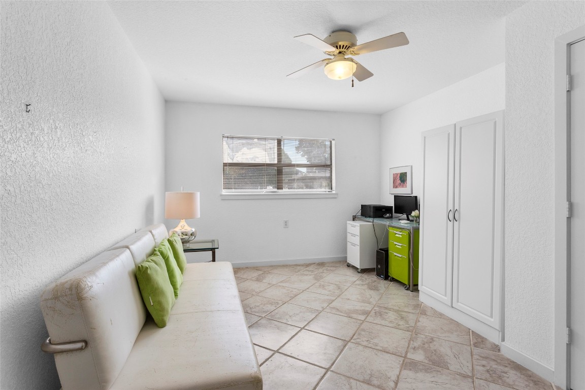 67 Harbor Lane Kemah, TX 77565 - Photo 32 of 47 a living room with a couch and a chandelier