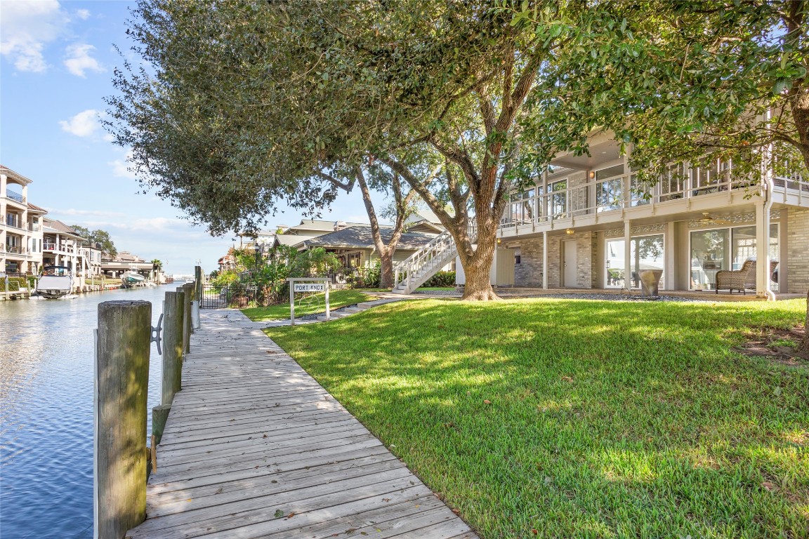 67 Harbor Lane Kemah, TX 77565 - Photo 37 of 47 a front view of a house with a garden and trees