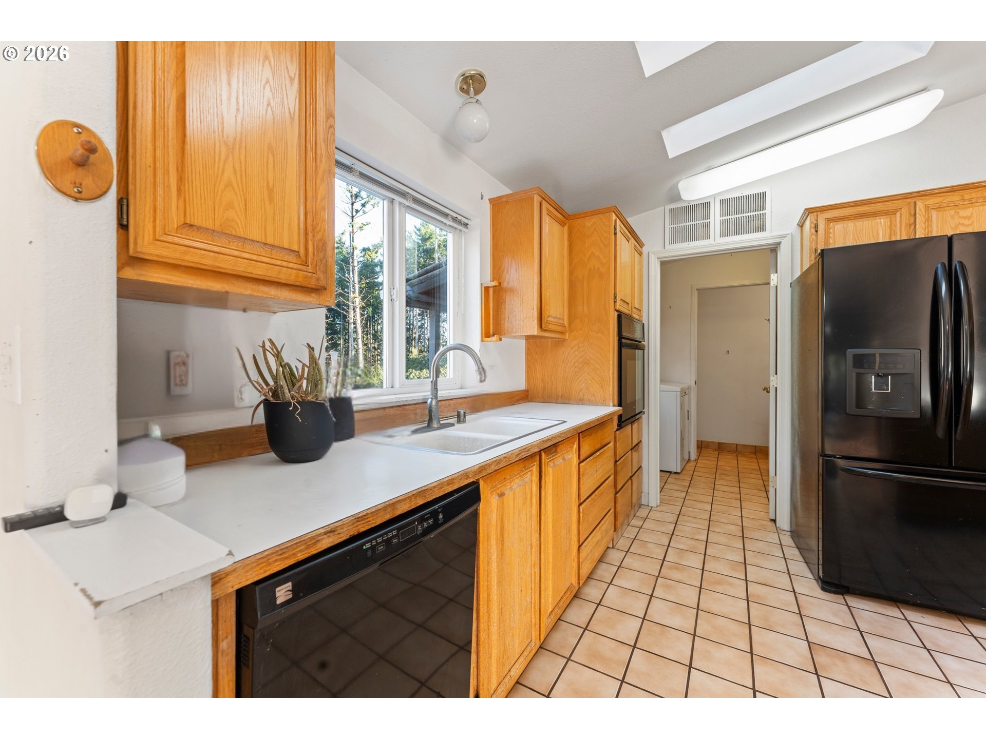 24130 South Hayden Road Estacada, OR 97023 - Photo 8 of 28 a kitchen with stainless steel appliances granite countertop a sink and a refrigerator