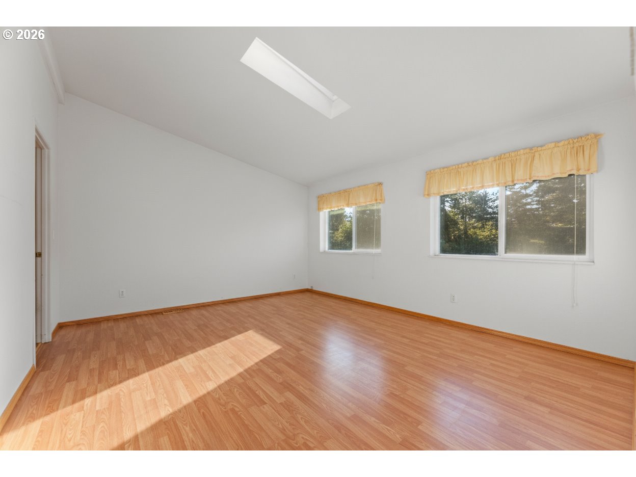 24130 South Hayden Road Estacada, OR 97023 - Photo 10 of 28 a view of an empty room with wooden floor and windows
