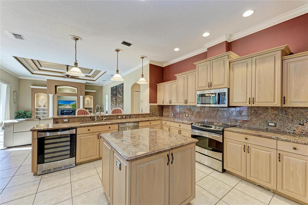 5060 Robinsong Road Sarasota, FL 34233 - Photo 17 of 42 a kitchen with stainless steel appliances granite countertop a sink and cabinets