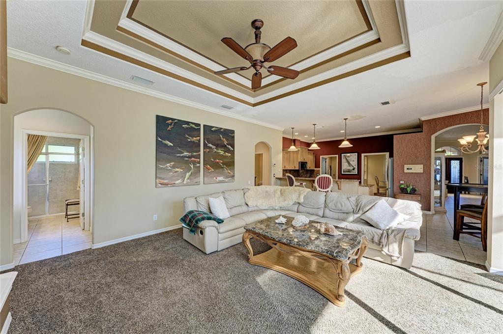 5060 Robinsong Road Sarasota, FL 34233 - Photo 20 of 42 a living room with furniture a ceiling fan and a rug