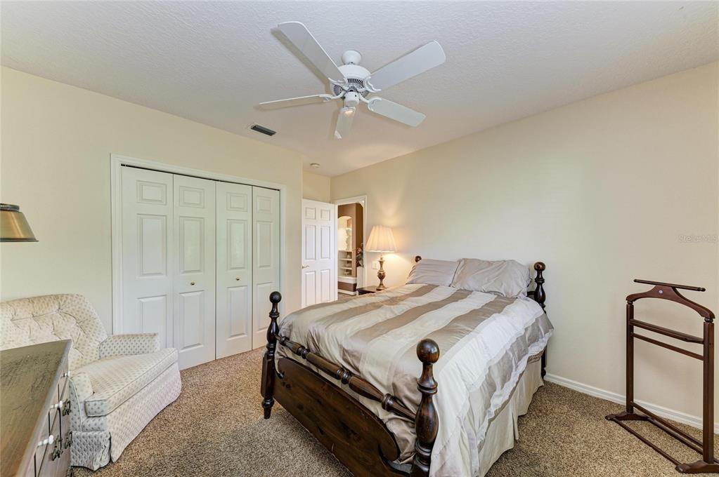 5060 Robinsong Road Sarasota, FL 34233 - Photo 30 of 42 a bedroom with a bed and a chandelier