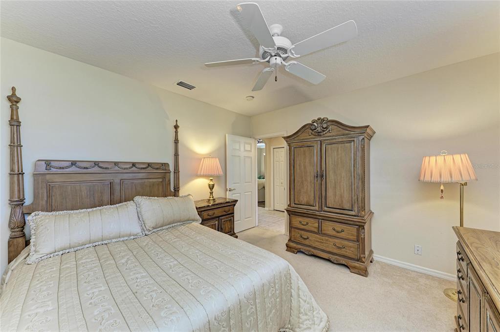 5060 Robinsong Road Sarasota, FL 34233 - Photo 33 of 42 a spacious bedroom with a bed and dresser