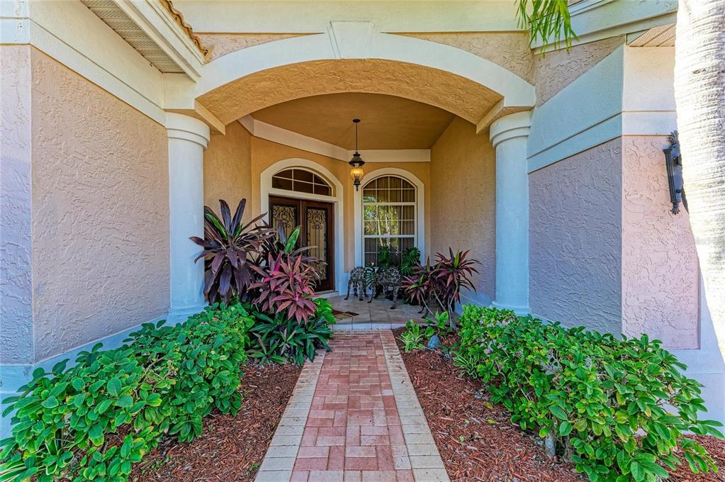 5060 Robinsong Road Sarasota, FL 34233 - Photo 7 of 42 a front view of a house with garden