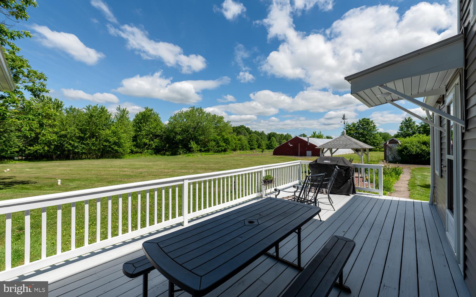 222 Blue School Road Perkasie, PA 18944 - Photo 53 of 77 a view of a deck with wooden floor barbeque oven and outdoor seating