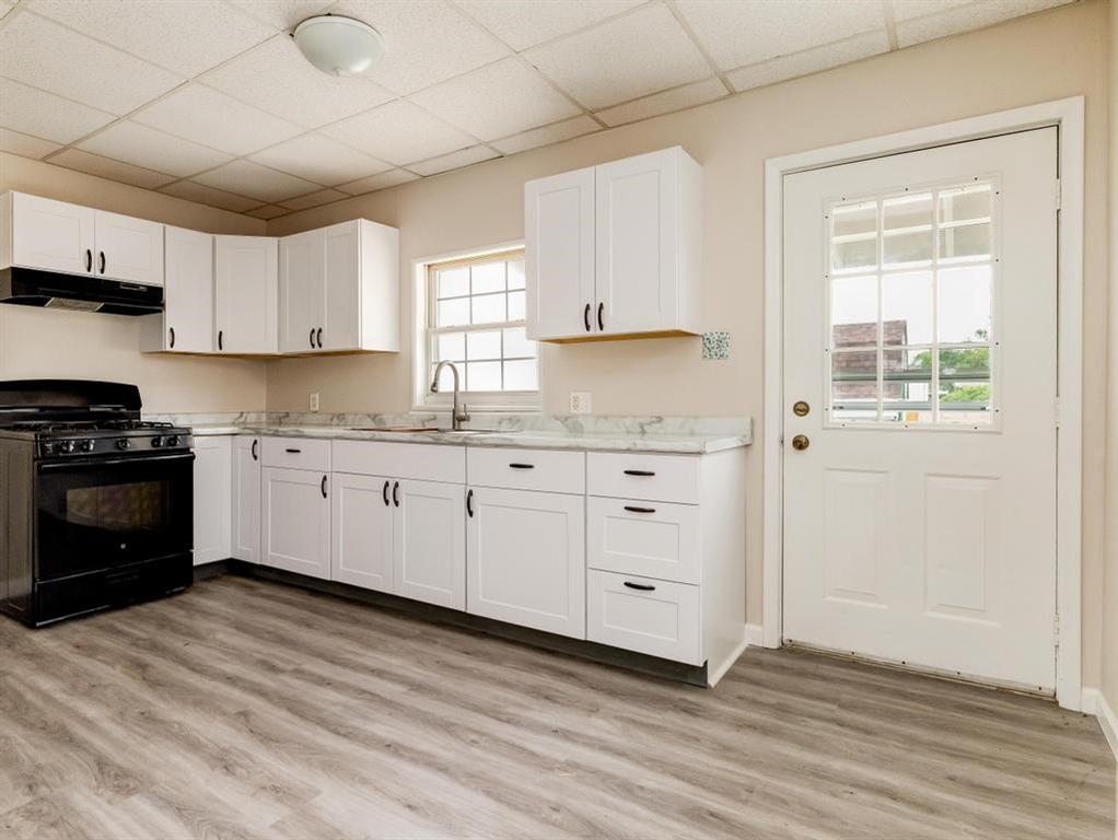 448 Park Street Rochester, PA 15074 - Photo 7 of 29 a kitchen with granite countertop white cabinets and white appliances